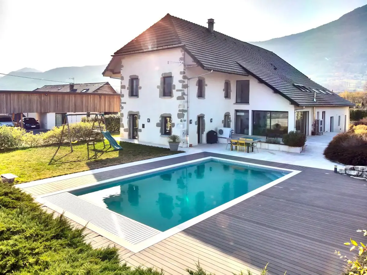 La maison familiale en pierre et sa piscine, au pied des montagnes